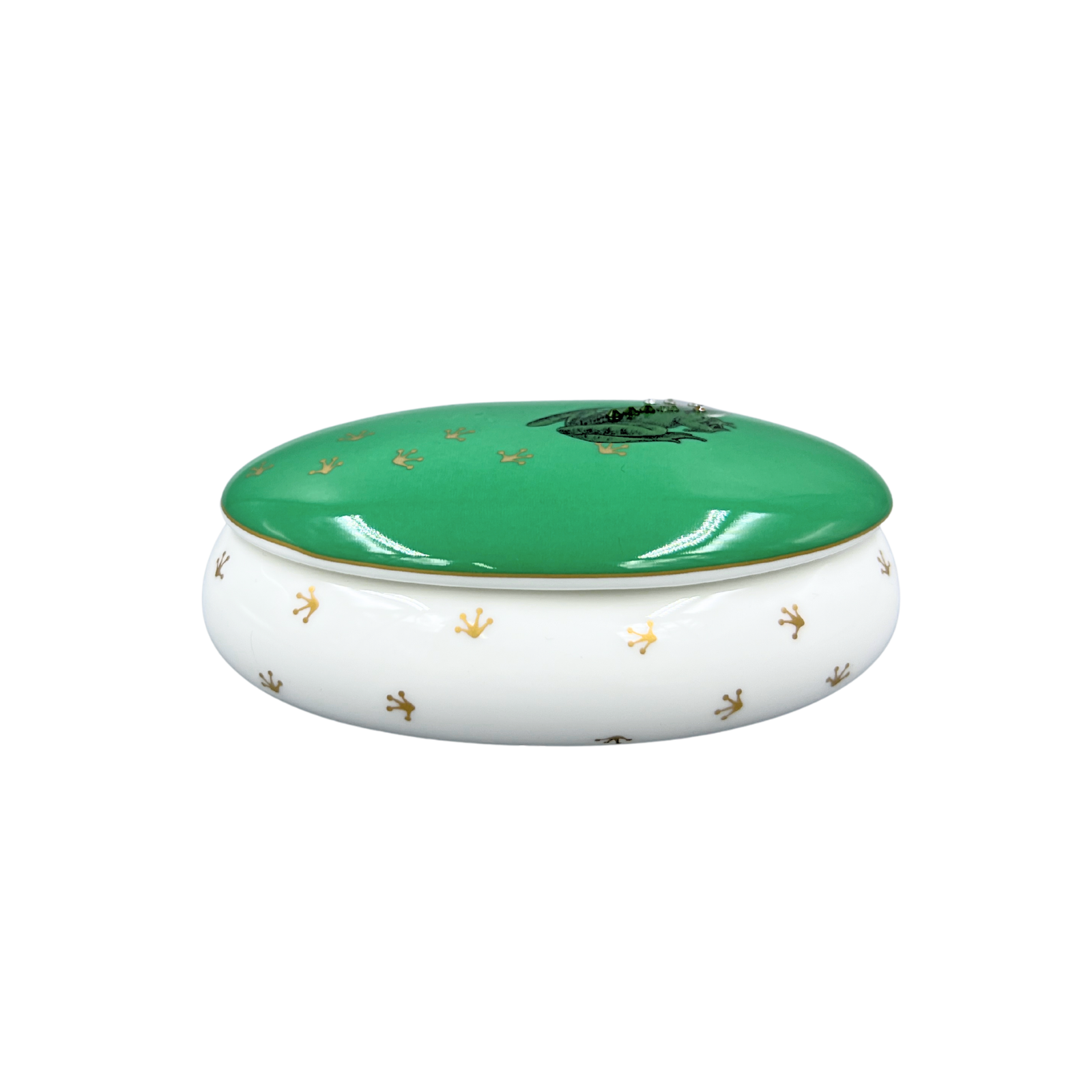Green and white ceramic dish with gold accents on a white background